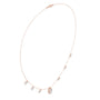 Rose gold halo diamond necklace with small linked stones and baguette centerpiece