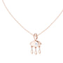 Rose gold evil eye pendant with eye-shaped center and dangling drop charms, on chain