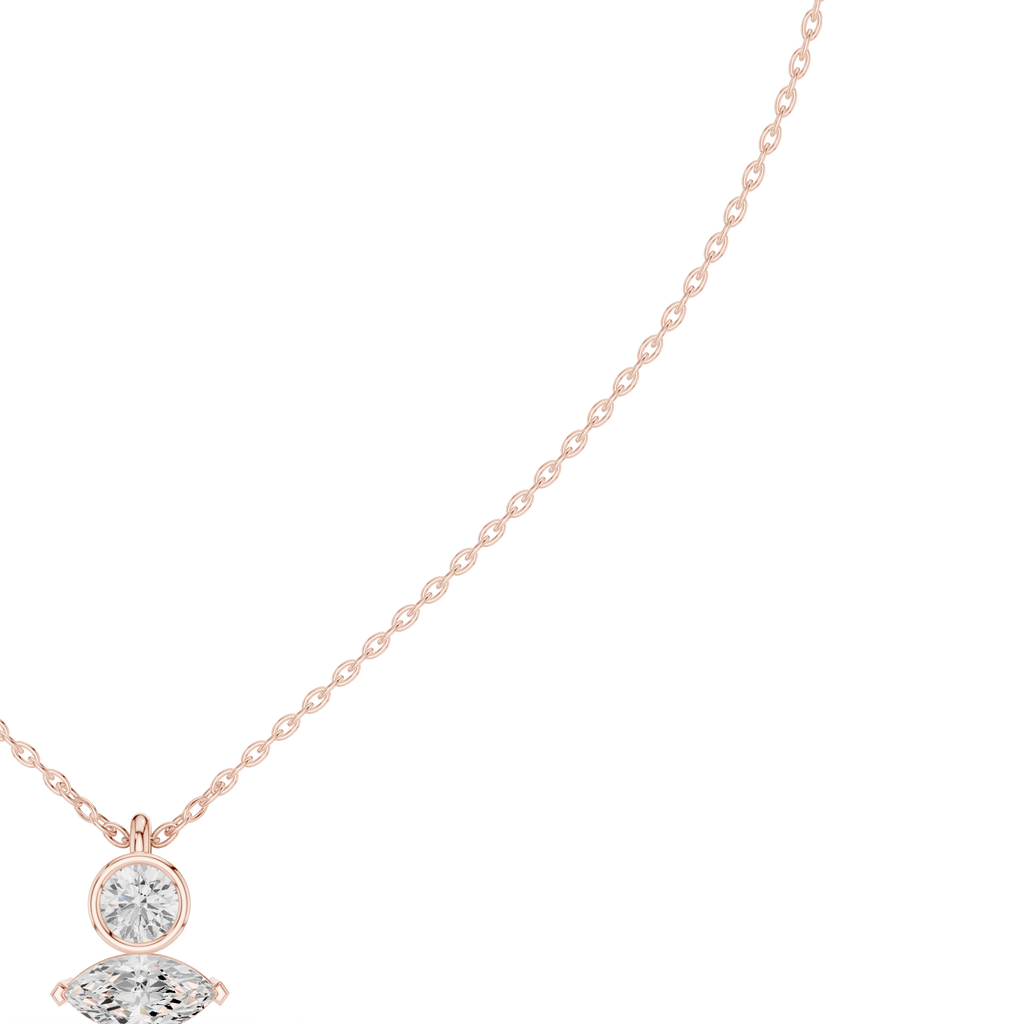 Rose gold diamond drop pendant featuring a round center stone and marquise accent