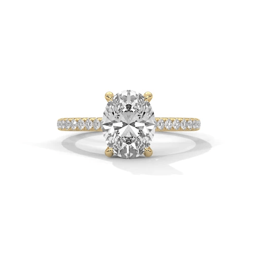 Oval diamond ring in yellow gold with pavé band and raised center stone