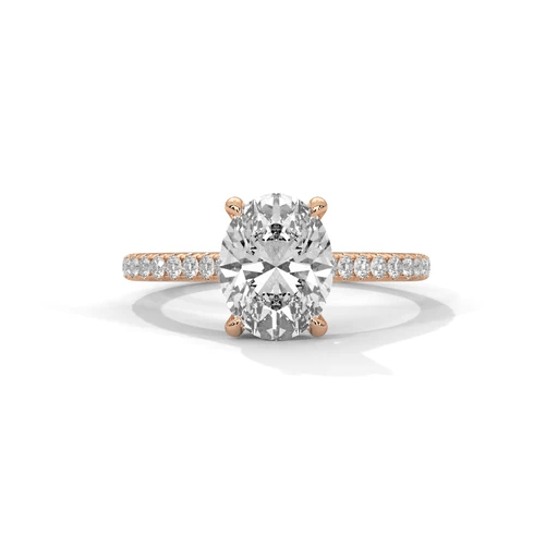 Oval diamond ring in rose gold with pavé band and raised center stone