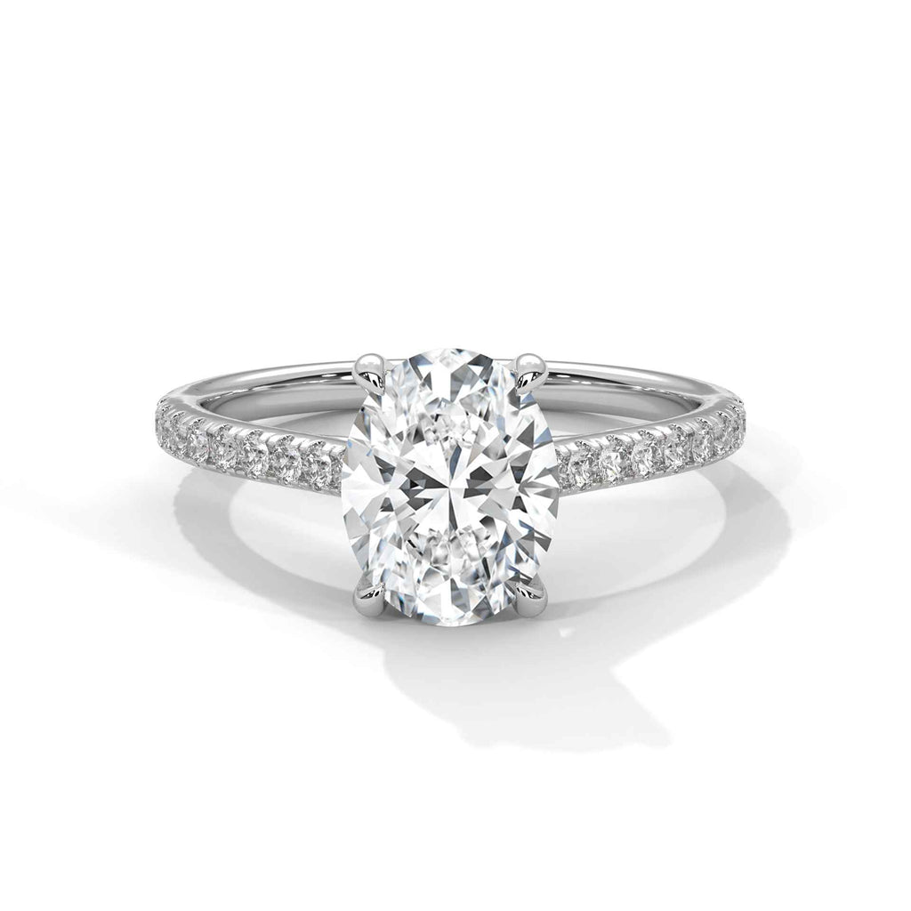 Oval engagement ring in platinum with pavé band and cathedral-set oval center diamond