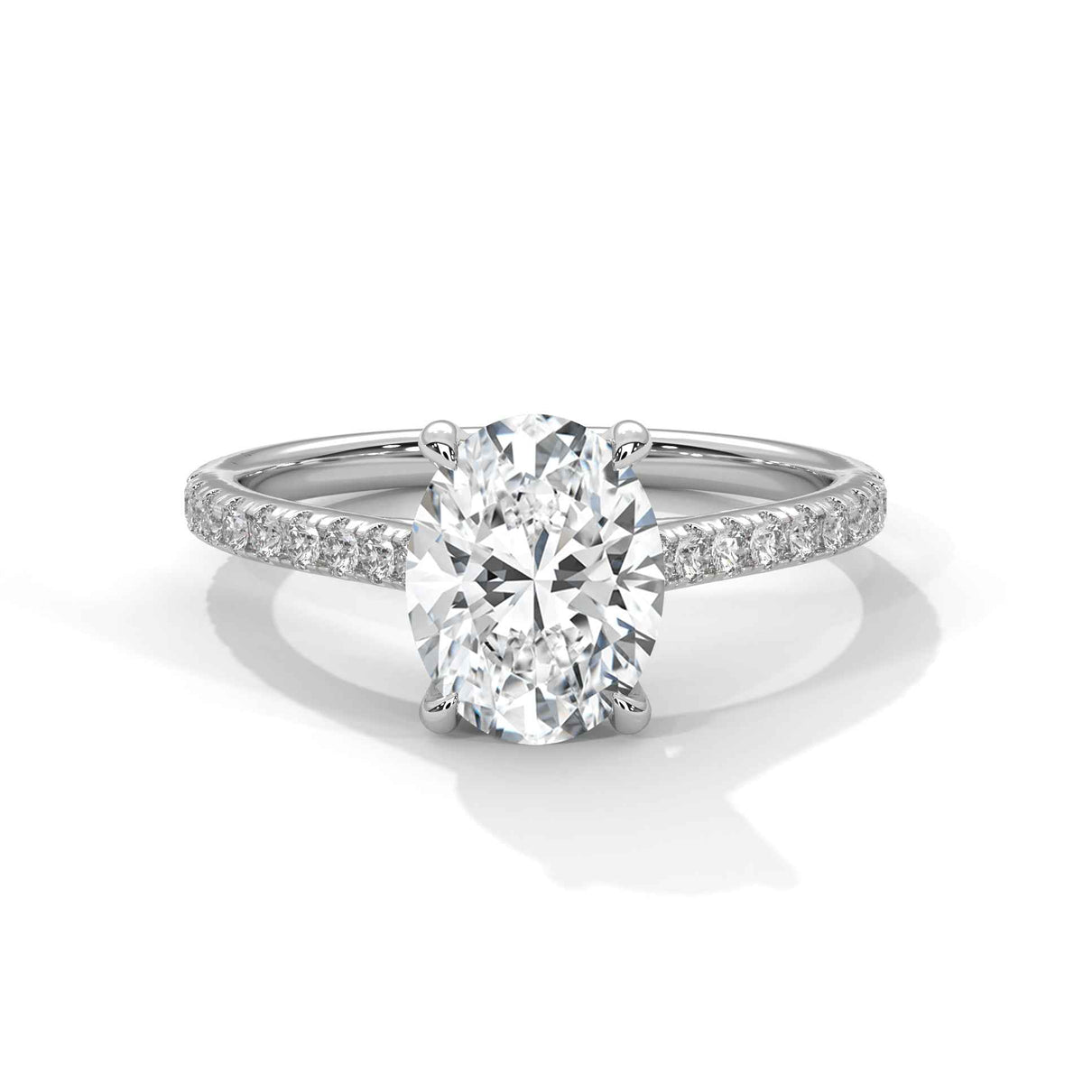 Oval center diamond ring in white gold with pavé band and four-prong setting