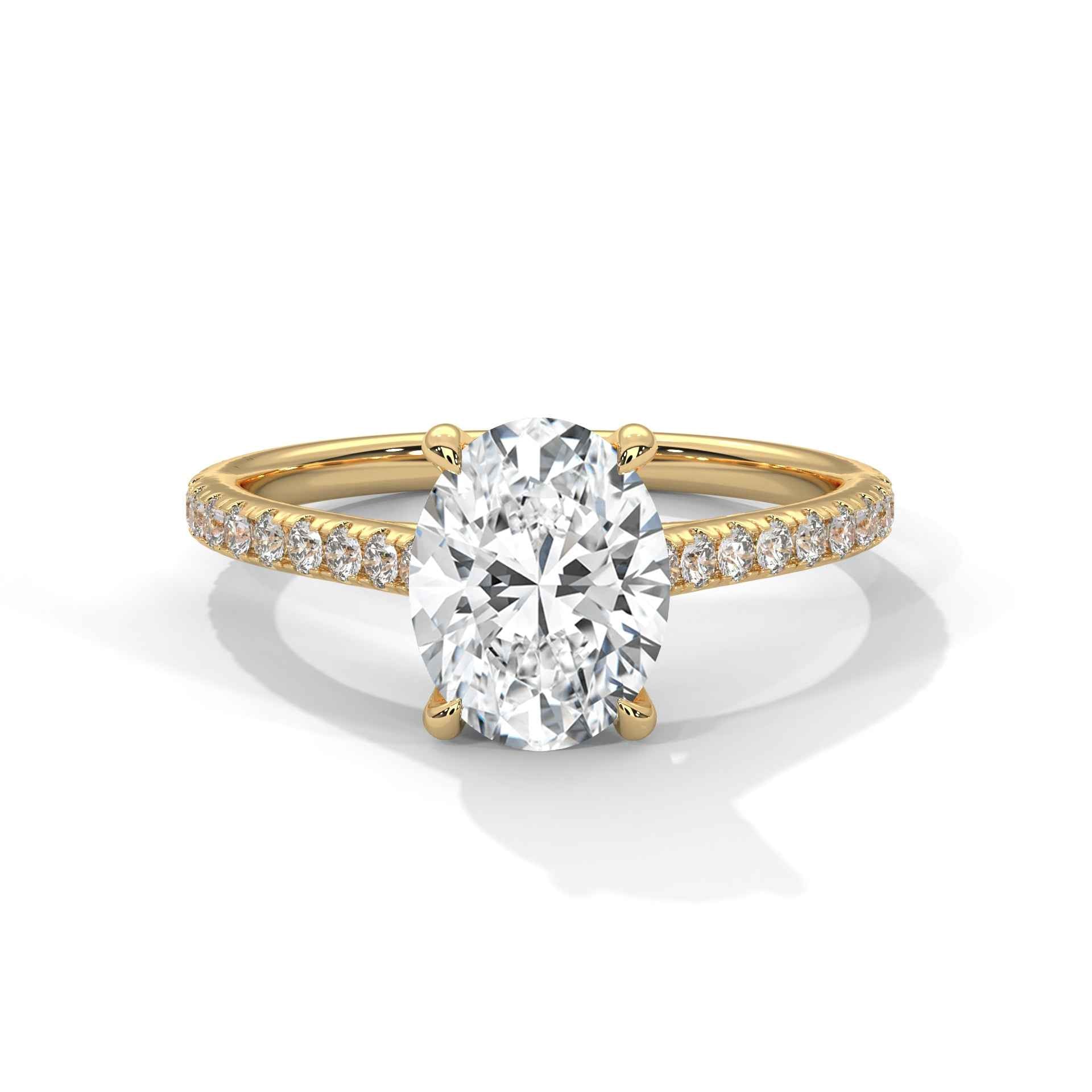 Oval center diamond ring in yellow gold with pavé band and four-prong setting
