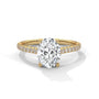 Oval center diamond ring in yellow gold with pavé band and four-prong setting