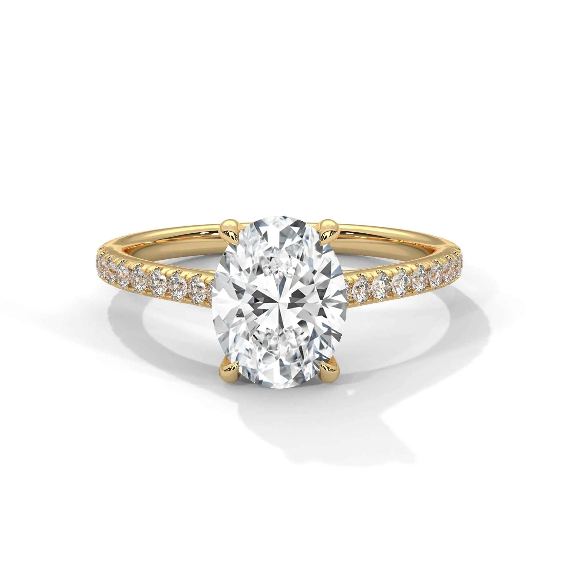 Oval center diamond ring in yellow gold with pavé band and four-prong setting