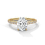 Oval center diamond ring in yellow gold with pavé band and four-prong setting