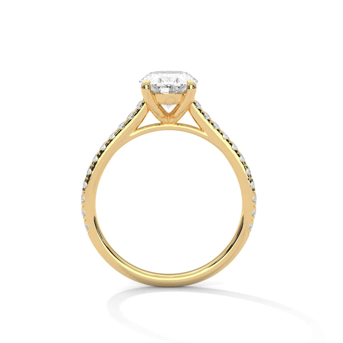 Oval diamond ring in yellow gold with four-prong setting and decorative shoulders