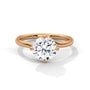 Rose gold diamond ring with a round center stone and twisted V-shaped prong setting