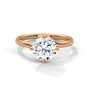 Rose gold diamond ring with a round center stone and twisted V-shaped prong setting