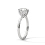 White gold diamond ring in side view with a round center stone and twisted top