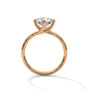 Gold diamond ring with a round center stone and twisted V-shaped prong setting