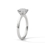 White gold round diamond solitaire ring with four-prong setting, side view