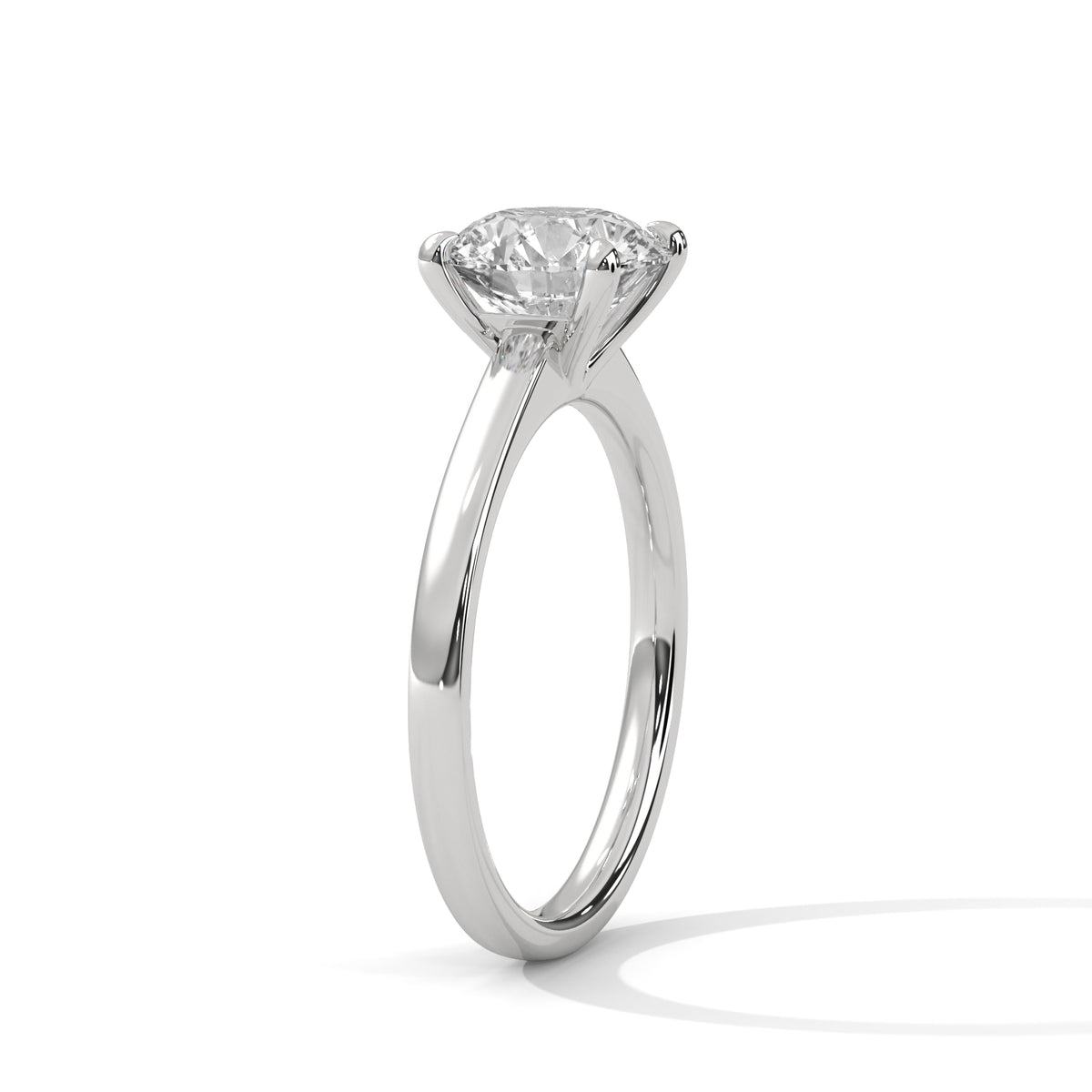 White gold round diamond solitaire ring with four-prong setting, side view