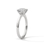 White gold round diamond solitaire ring with four-prong setting, side view
