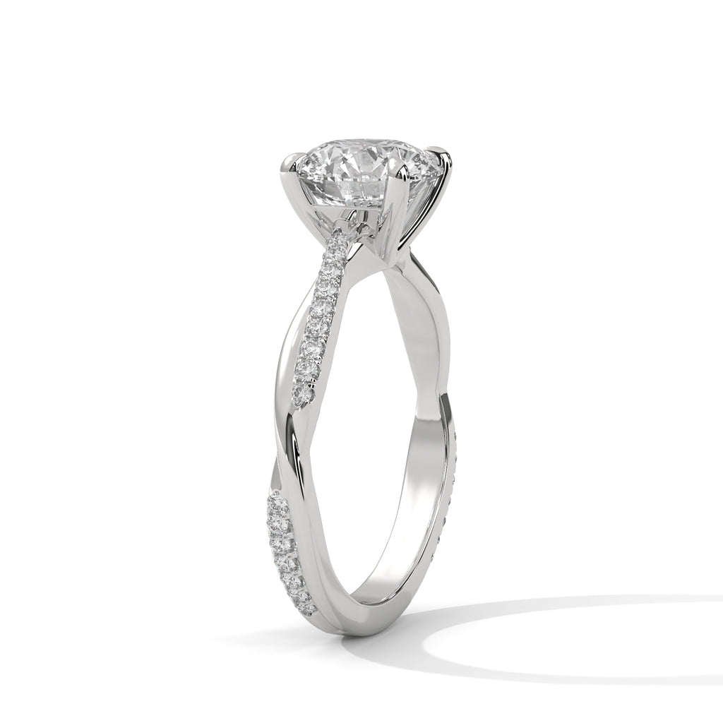 White gold engagement ring with round center diamond and pavé vine detailing on shank