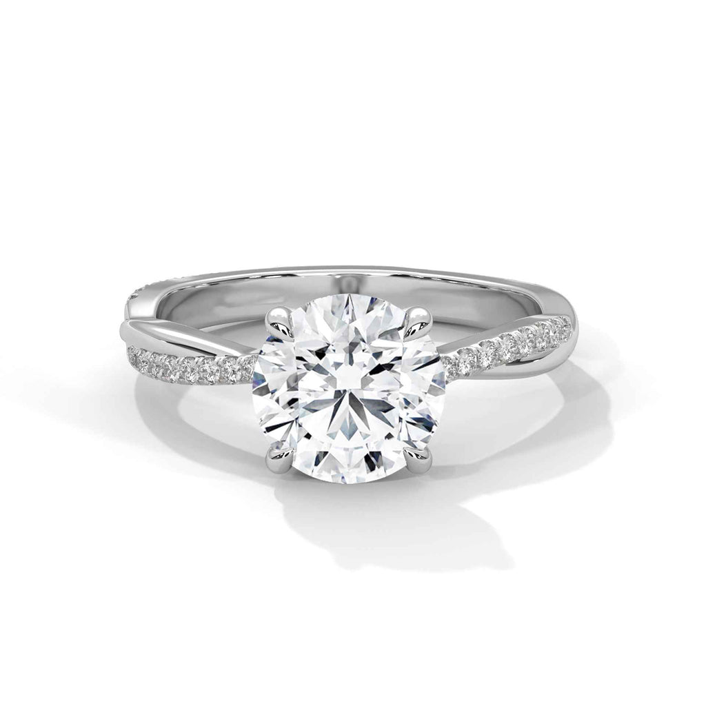 White gold diamond engagement ring with round center diamond and pavé band shoulders