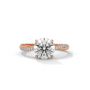 Rose gold diamond ring with a round center stone and side diamond accents