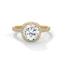 Cushion halo diamond ring with cushion-cut center stone and pavé band in yellow gold