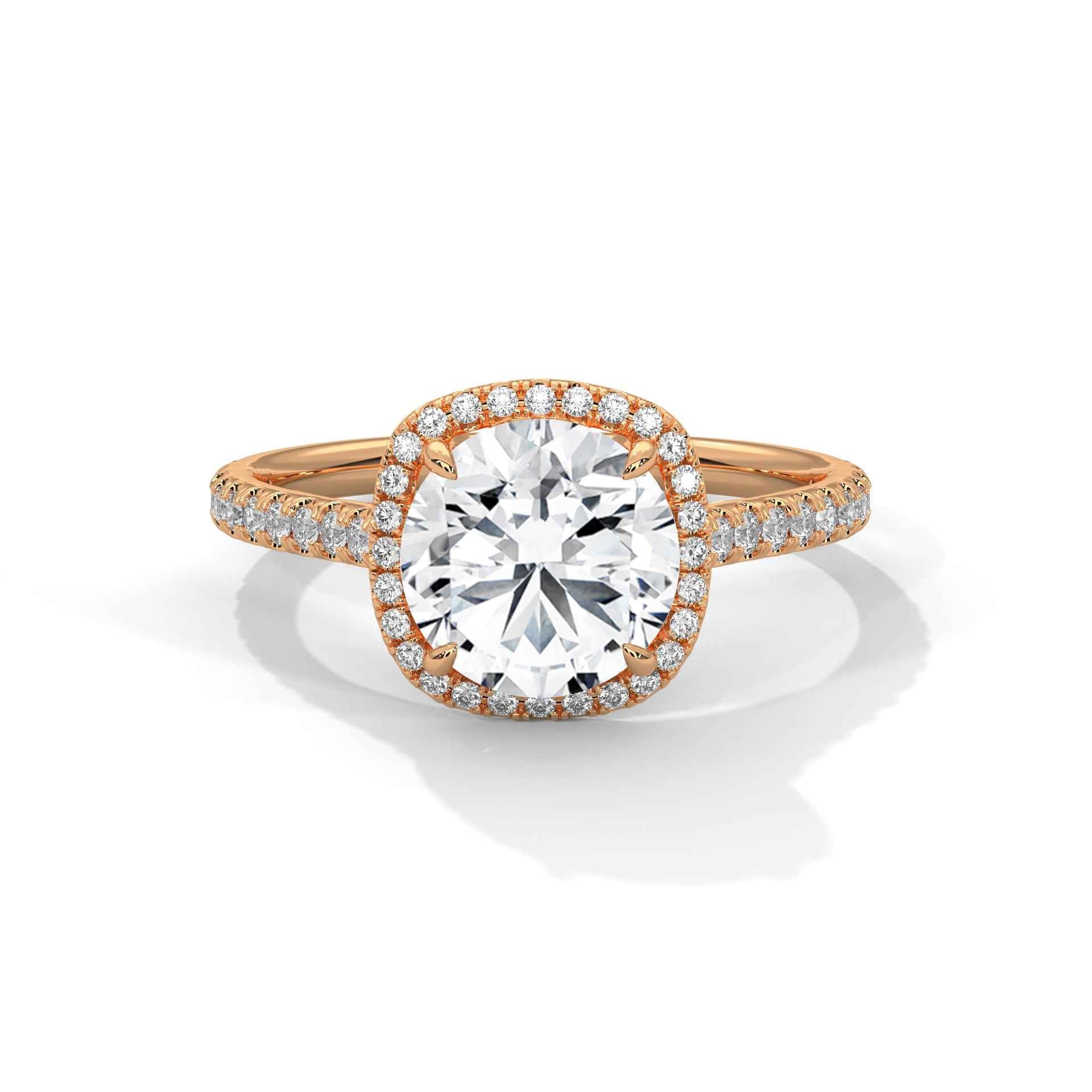 Rose-gold tone round-cut diamond halo engagement ring with pavé band and prongs