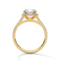 Cushion halo diamond ring in yellow gold with pavé side stones and prong-set center
