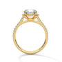 Cushion halo diamond ring in yellow gold with pavé side stones and prong-set center