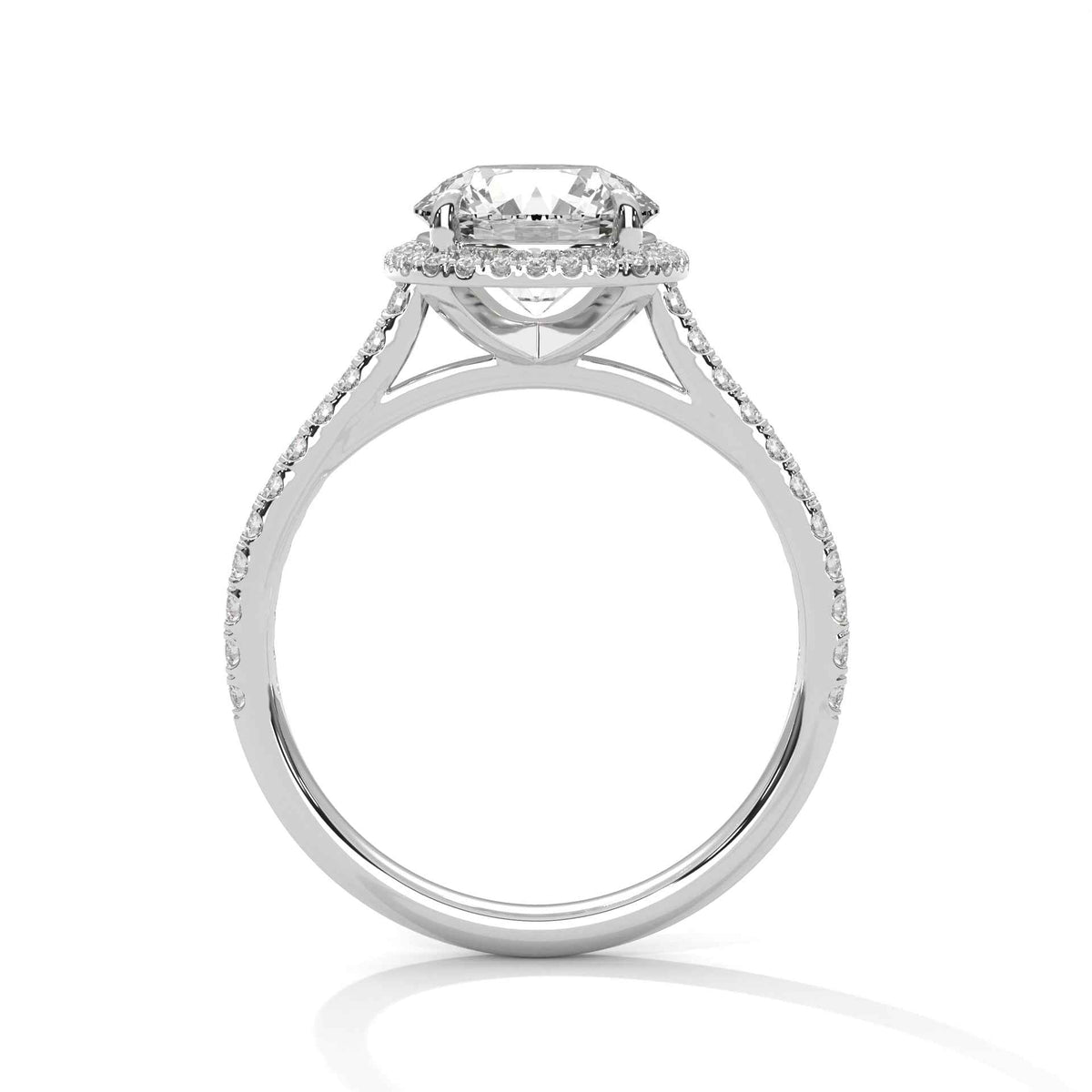 Cushion halo diamond ring in platinum with pavé band and prong-set cushion center