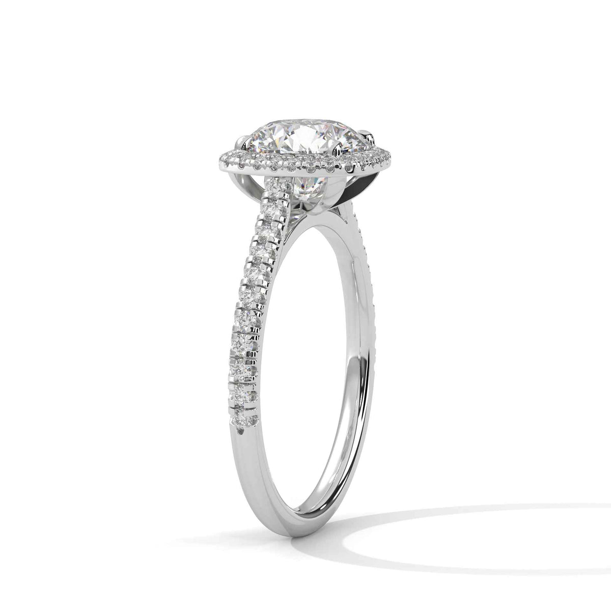 Cushion halo diamond ring side view in platinum with prong-set cushion center and pavé