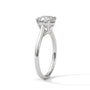 Cushion-cut solitaire engagement ring in platinum with cathedral-style prongs