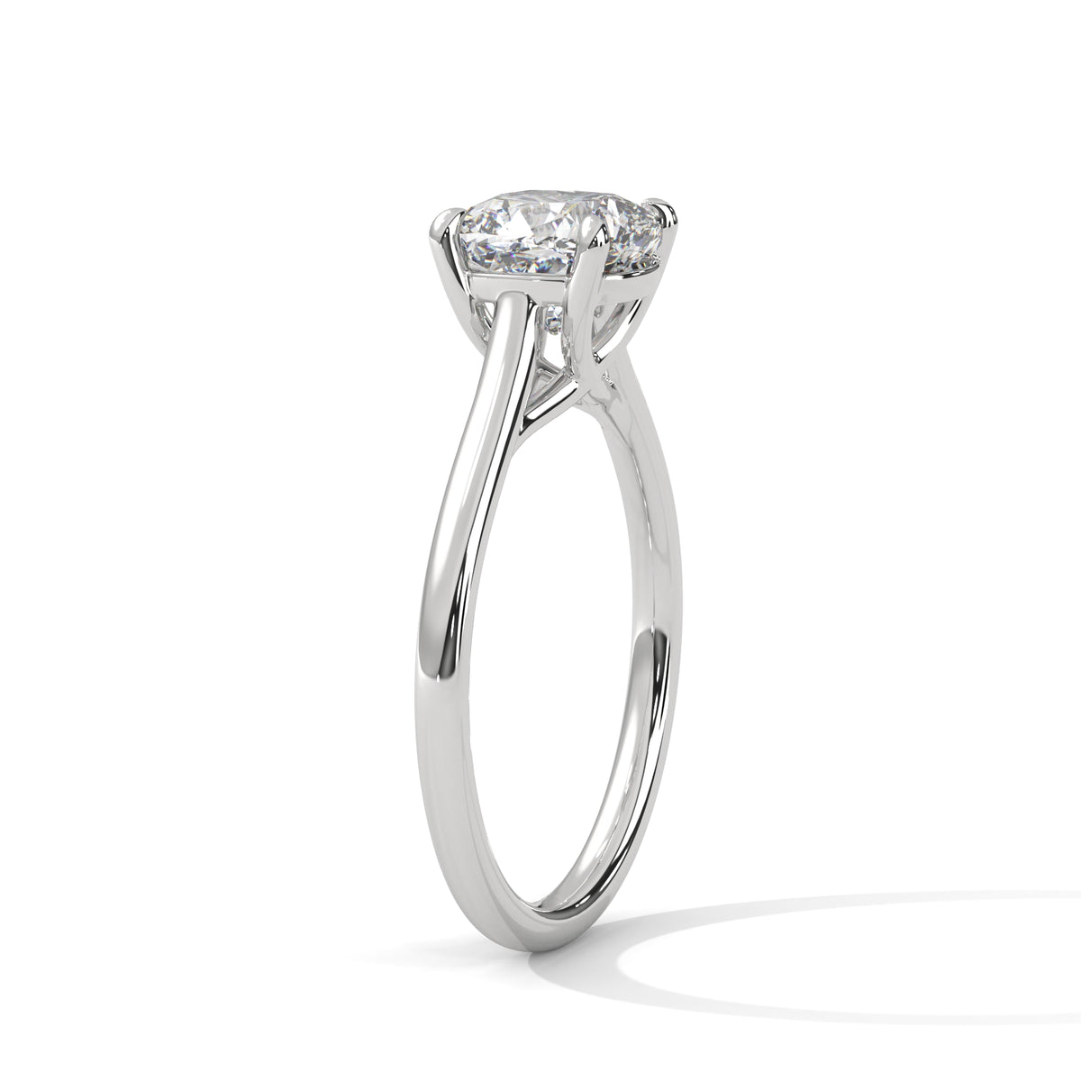 Cushion-cut solitaire engagement ring in platinum with cathedral-style prongs