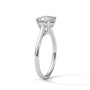 Cushion-cut solitaire engagement ring in platinum with cathedral-style prongs