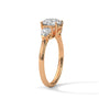 Three-stone diamond ring in rose gold with a round center stone and two side stones