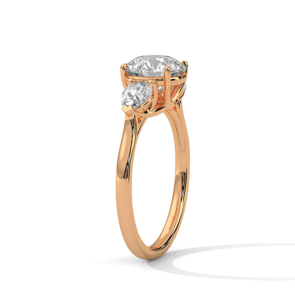 Three-stone diamond ring in rose gold with a round center stone and two side stones