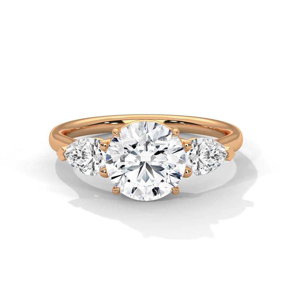 Rose gold three-stone engagement ring with round center and round side stones