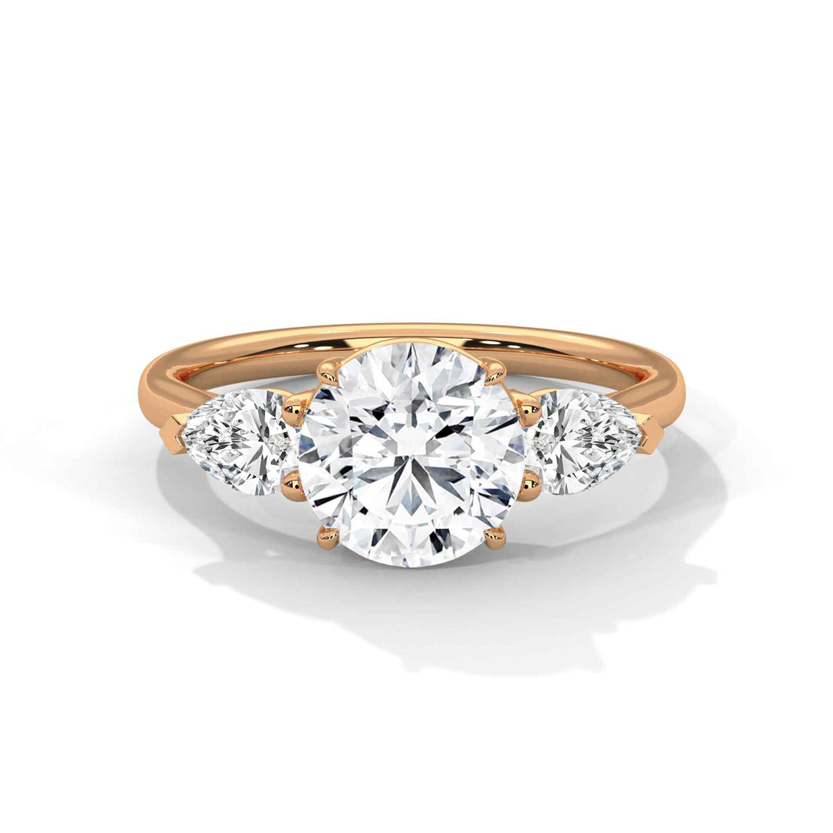 Three-stone diamond ring in rose gold with a round center stone and two side stones