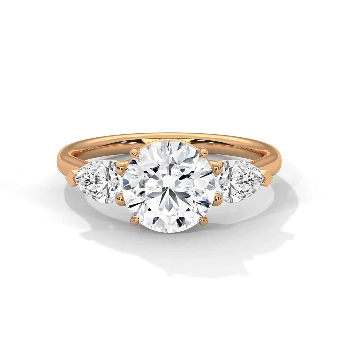 Three-stone diamond ring in rose gold with a round center stone and two side stones