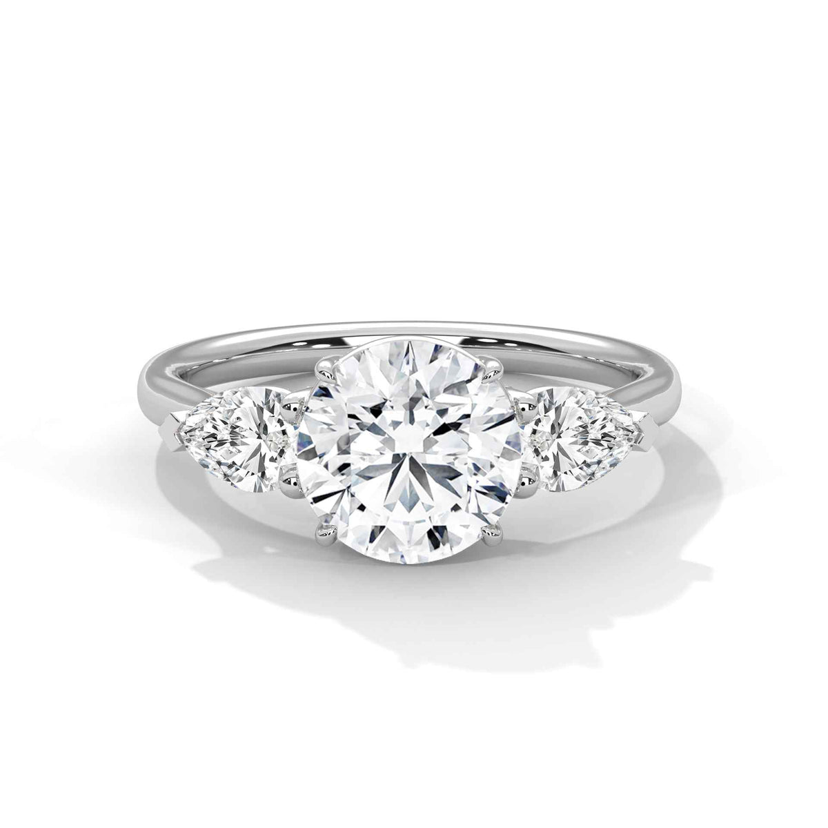 Three-stone diamond ring in platinum with a round center stone and two side stones
