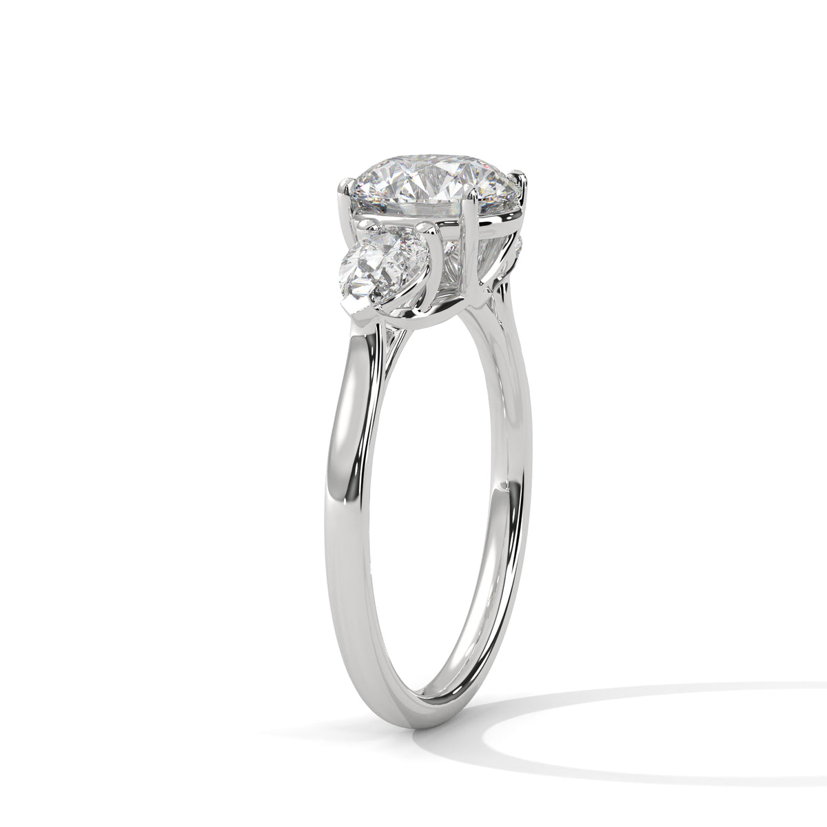 Three-stone diamond ring in platinum with a round center stone and two side stones