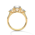 Yellow gold three-stone engagement ring with oval center and pear side stones