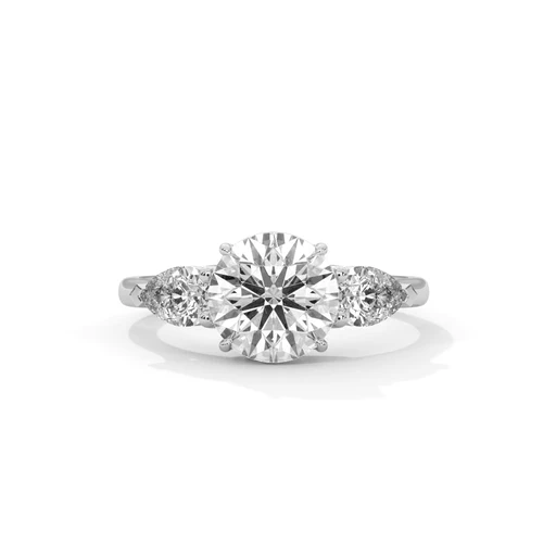 Three-stone diamond ring with round center and side diamonds, white metal band