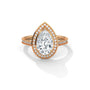 Pear halo diamond ring, rose gold with pear center and pavé side band.