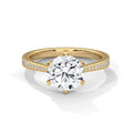 Yellow gold solitaire engagement ring with round center diamond and pavé band