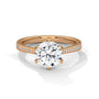 Rose gold solitaire engagement ring with round center diamond and pavé band