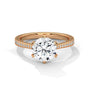 Rose gold solitaire engagement ring with round center diamond and pavé band