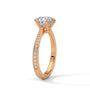Rose gold solitaire engagement ring with round center diamond and pavé side stones