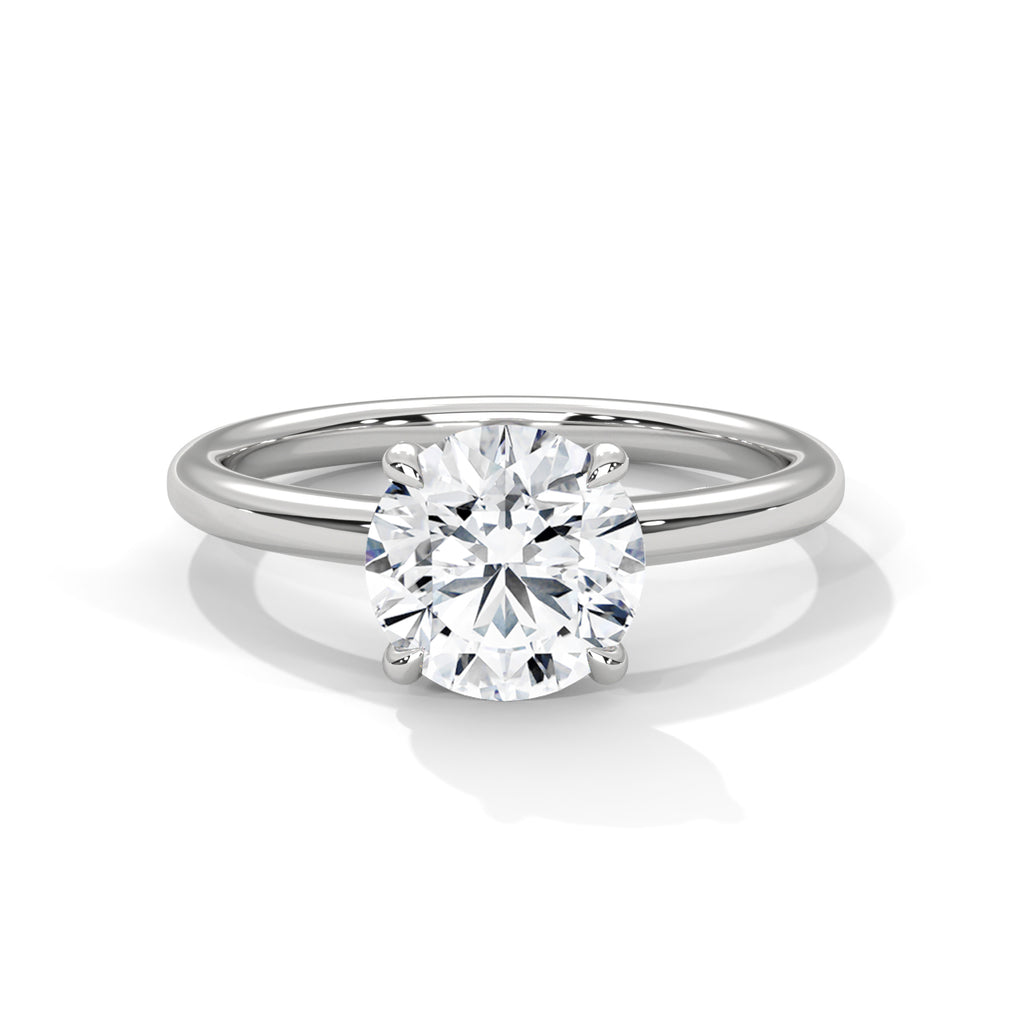 White metal solitaire engagement ring with round diamond and slim band