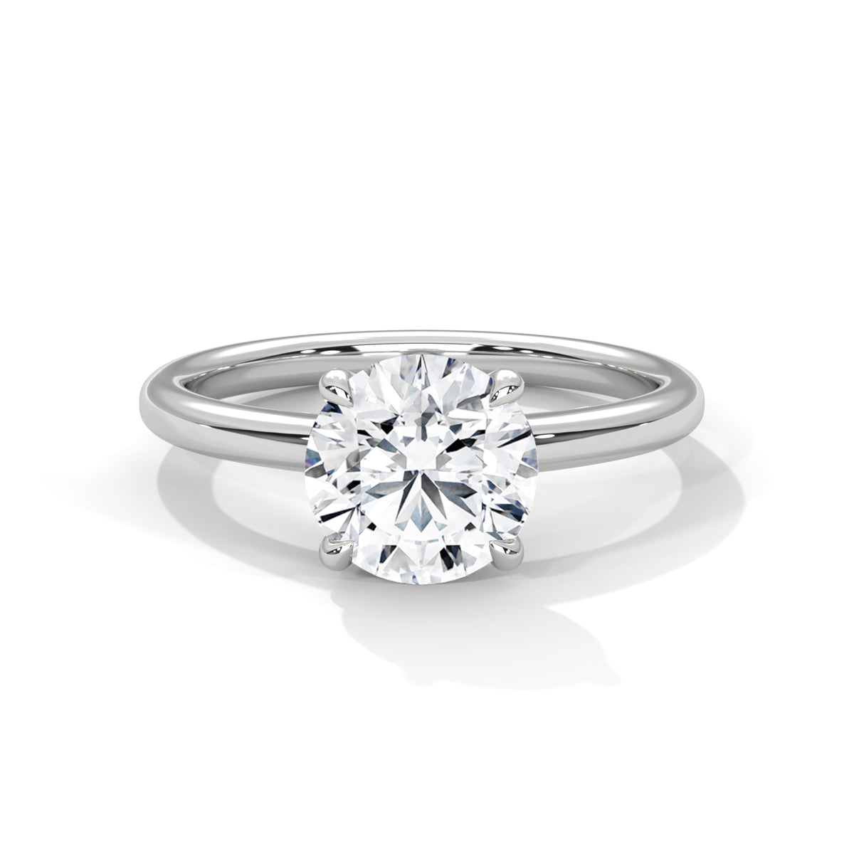 White metal solitaire engagement ring with round diamond and slim band