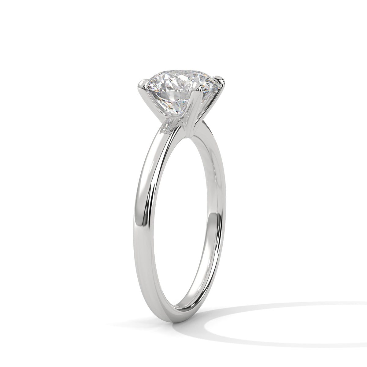 White metal solitaire ring with round center diamond, four-prong basket setting
