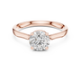 Rose gold solitaire engagement ring with round center diamond and hidden halo border