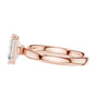 Rose gold emerald-cut solitaire diamond ring, profile view with four-prong head